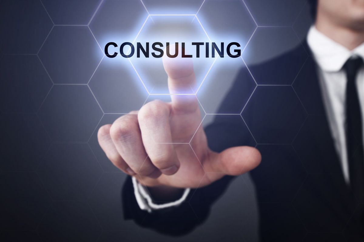 Businessman pressing button on touch screen interface and select "Consulting". Business concept. Internet concept.